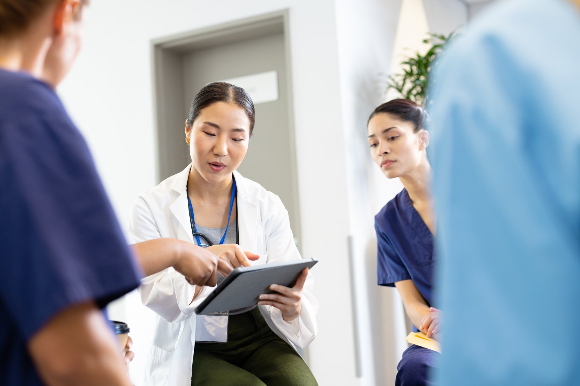 asian-female-doctor-with-tablet-sitting-in-discuss-2023-11-27-05-19-52-utc