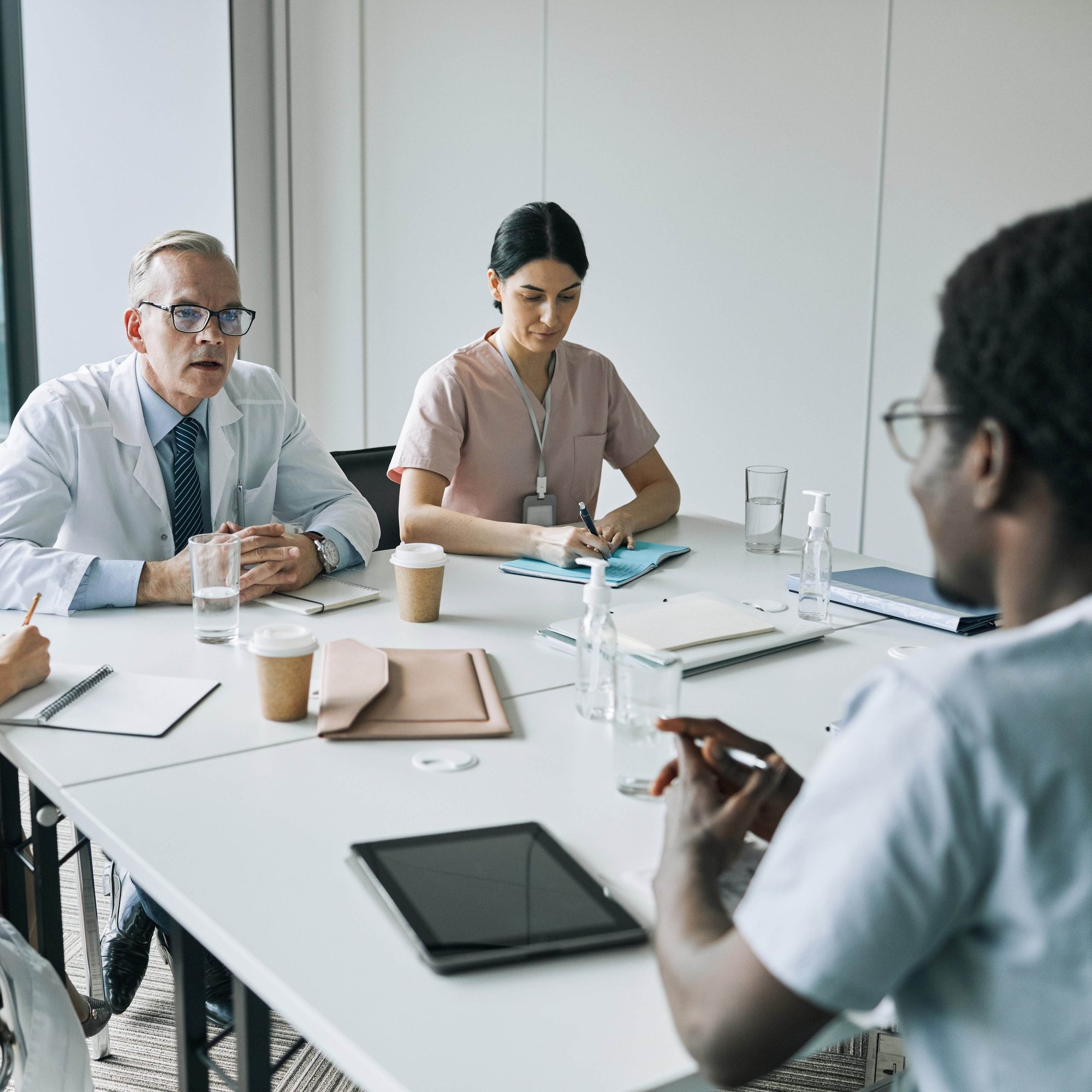 diverse-group-of-medics-at-meeting-table-2023-11-27-05-05-25-utc-optimised
