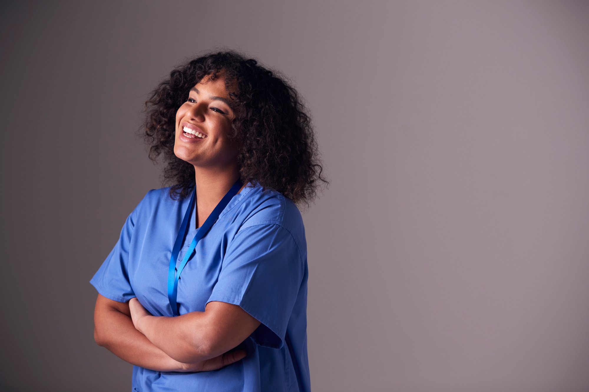 studio-portrait-of-female-nurse-wearing-scrubs-sta-2023-11-27-04-49-44-utc
